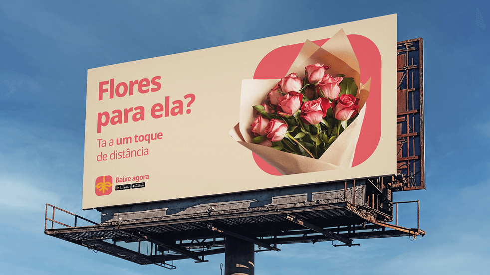 A billboard reading “Flores para ela? Tá a um toque de distância”
